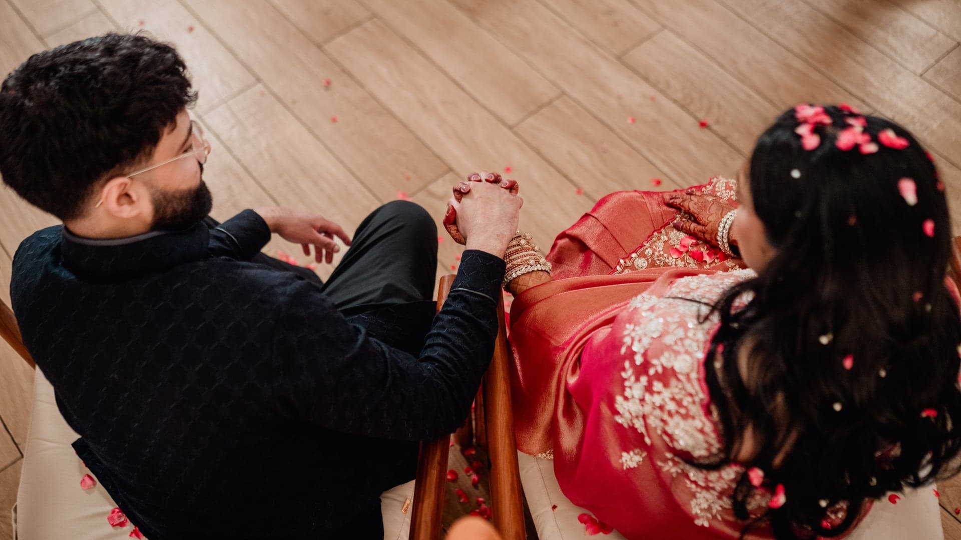 Sneha and Sudarshan holding hands during their baby shower