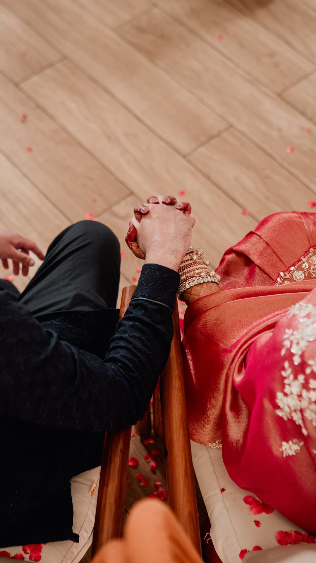 Sneha and Sudarshan holding hands during their baby shower